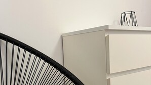 A modern room with a white cabinet, a black chair, and a mirror on the wall. - CASA FABRIZIO WITH VERANDA SEA VIEW AND TOWN CENTRE! OFFER € 200.00. INTERNET FR (Balestrate)