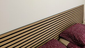 A bedroom with a wooden slatted headboard, a bed with red and beige bedding, and three framed floral artworks on the wall. - CASA FABRIZIO WITH VERANDA SEA VIEW AND TOWN CENTRE! OFFER € 200.00. INTERNET FR (Balestrate)
