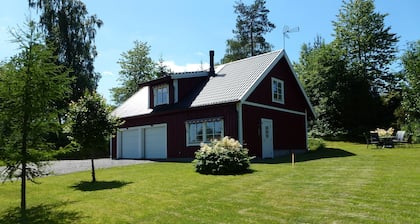 House With An Unique Gathering Of Hunting Trophies. View Of The Pond & Village