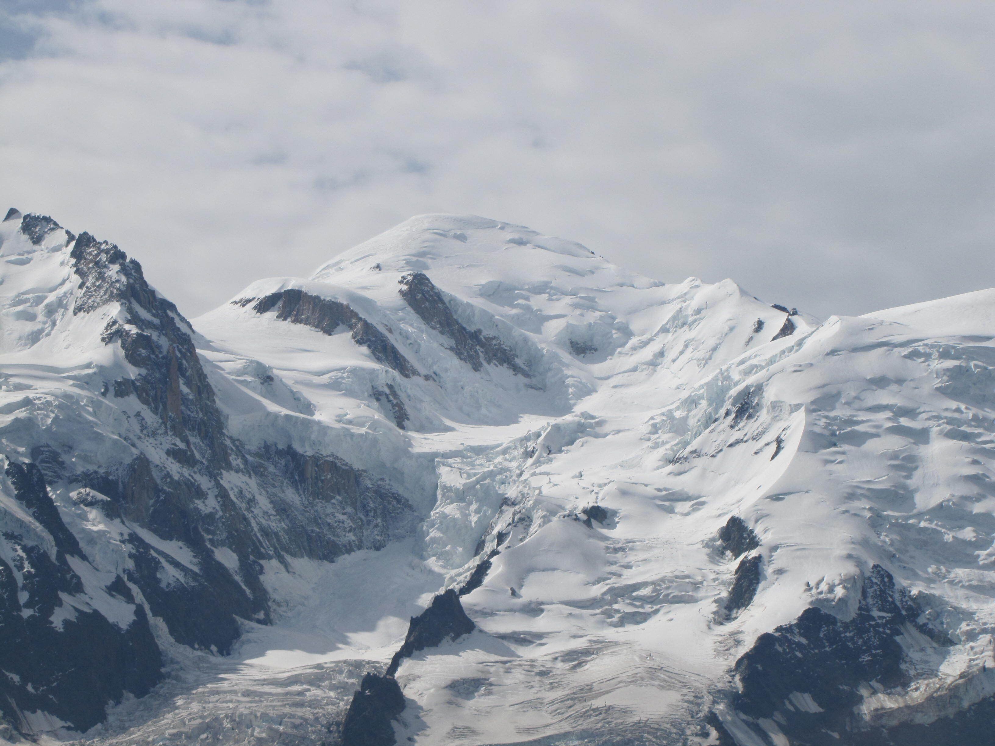 A snow-covered mountain landscape with rugged peaks and valleys.