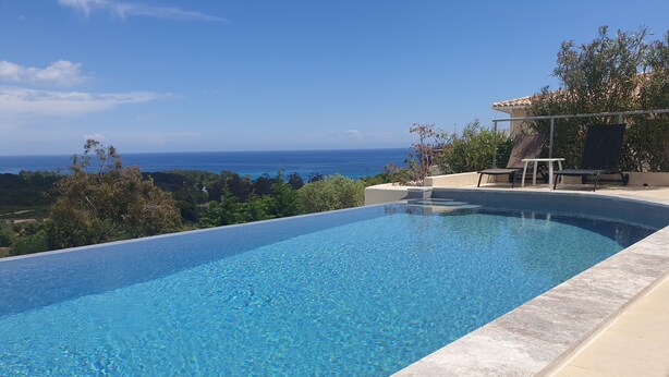 A clear blue infinity pool with a view of the ocean and greenery. - Apartment/ flat - Sari SolenzaraHouse with character (Sari-Solenzara)