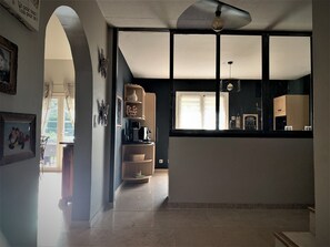 A spacious kitchen with a large window, a ceiling fan, and a built-in oven.