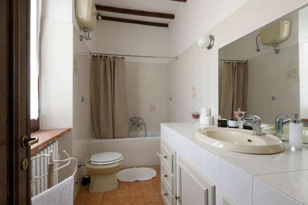A bathroom with a toilet, sink, and bathtub.