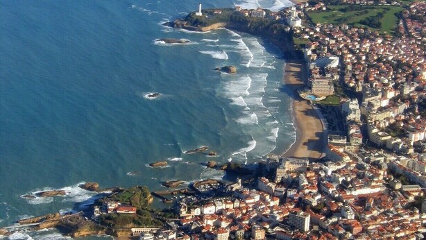 An aerial view of a coastal town with a beach, residential areas, and a lighthouse. - ANGLET T2 Classified - Beaches and Forest, Comfortable, Terrace 25m2, Baby equipment (Anglet)