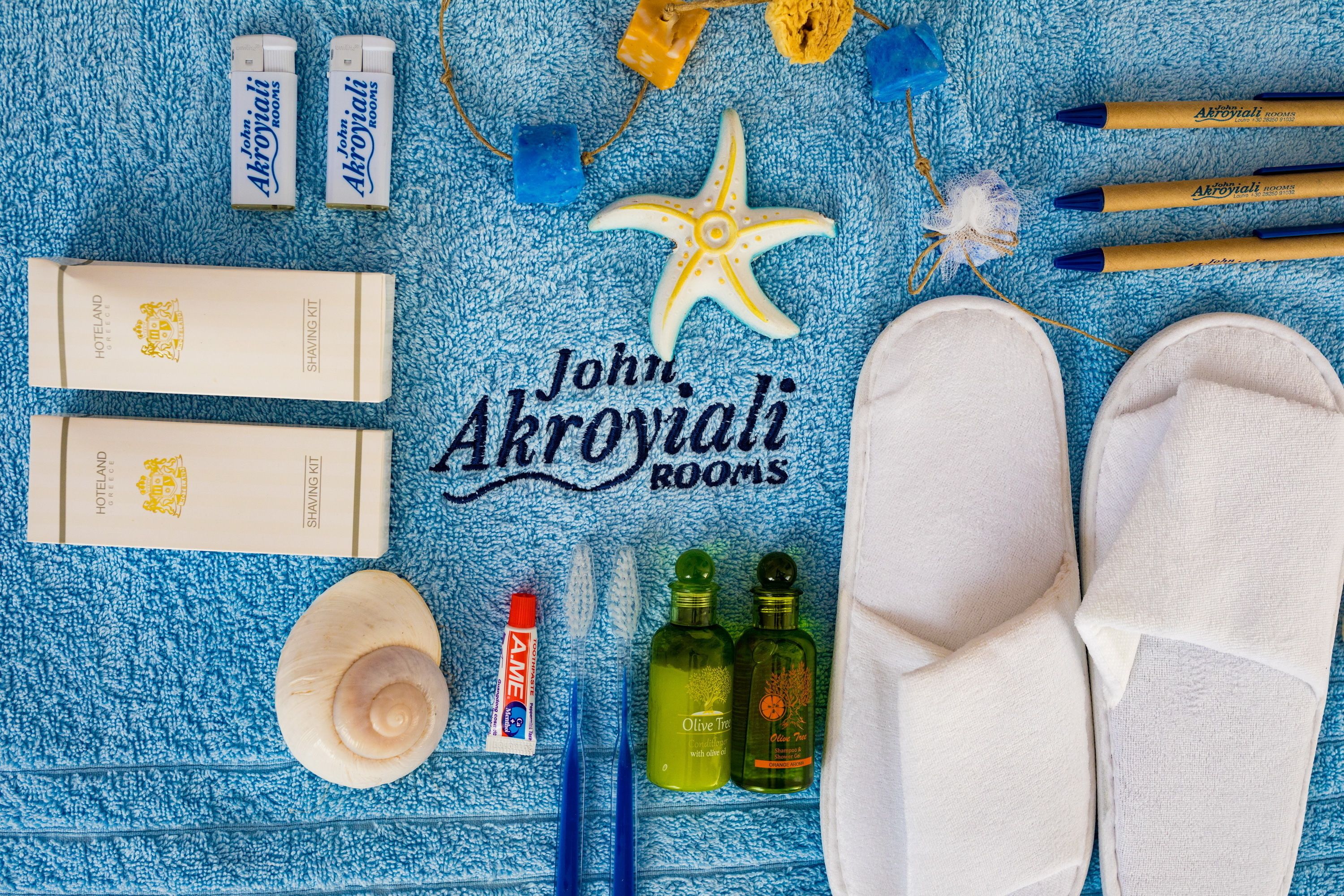 A bathroom setup with toiletries, a starfish decoration, and slippers.