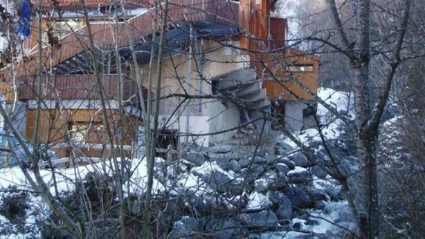 A wooden cabin with a stone foundation, a balcony, and a view of a snowy landscape. - Perfect  location quiet surroundings  spacious comfortable & functional  (Brides-Les-Bains)