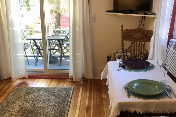 Living/dining room with slider to deck overlooking Wonson Cove