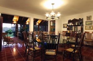 Enjoy meals in this dining area with a glass-top table and comfortable seating.