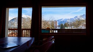 A room with a view of snow-covered mountains and a town. - COURCHEVEL 1850 RESIDENCE CHALET STYLE - BEAUTIFUL VIEW ON MASSIF DE LA VANOISE (Courchevel)