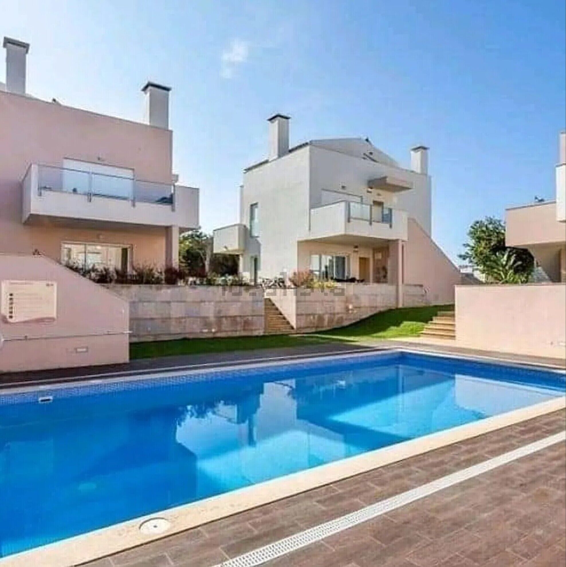 A modern residential building with a swimming pool.