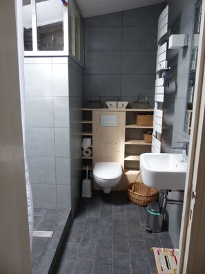 A compact bathroom with a toilet, sink, and shelves for toiletries. - Large capacity houses in the village (Les Portes-En-Ré)