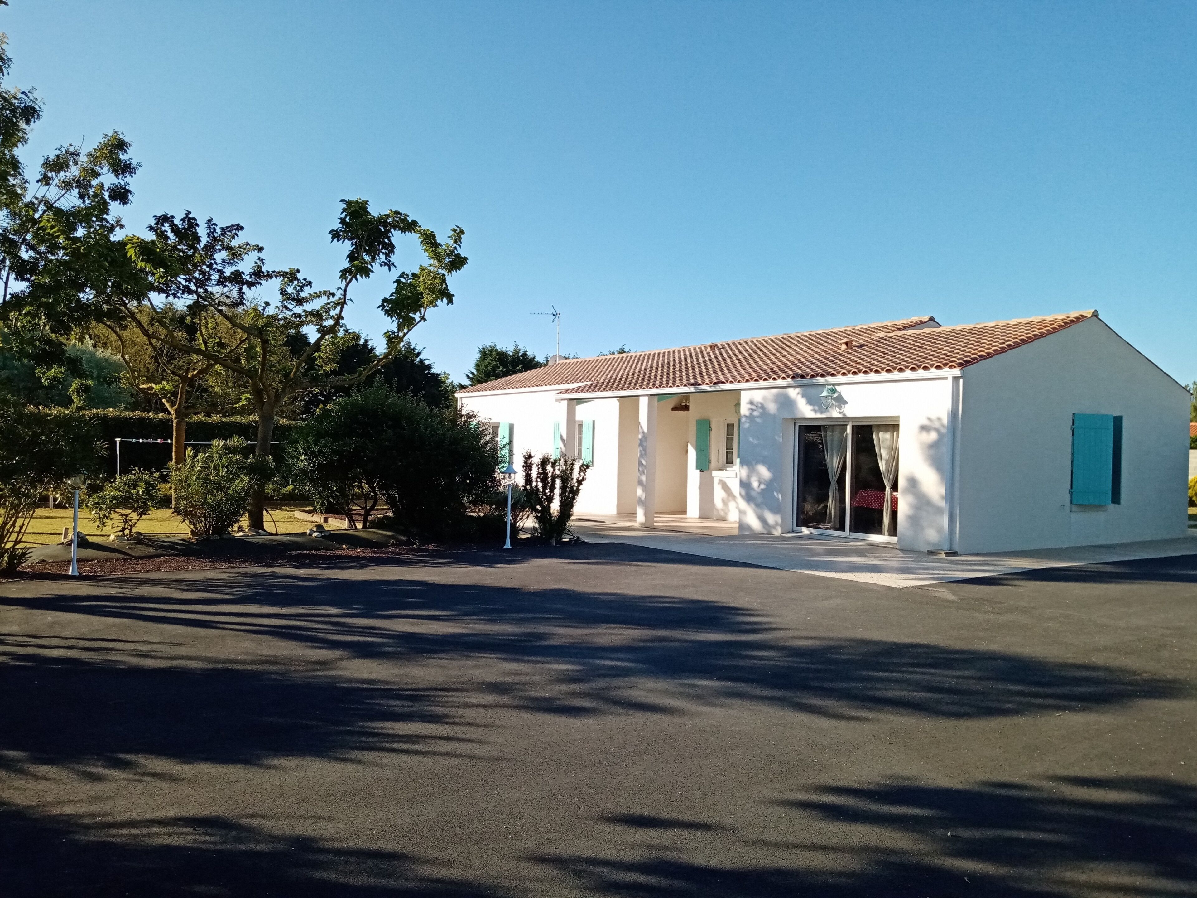 A single-story building with a tiled roof, a covered entrance, and a small porch area.