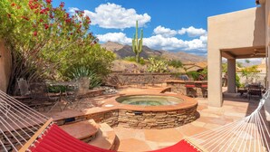 A hot tub surrounded by stone steps and a hammock. - Gated La Paloma Home, Private Lot with City & Mountain views (Tucson)