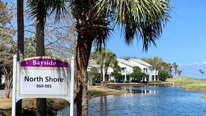 A sign for Bayside North Shore with a contact number.