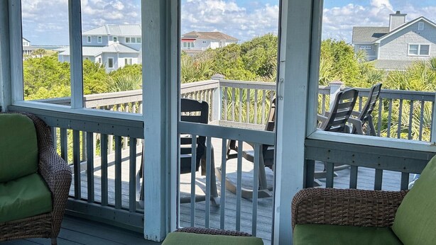 A covered porch with wicker furniture and a view of houses and greenery. - NOW AVAILABLE LABOR DAY, OCEAN views, 2 KING masters. 2 clubs- separate purchase (Bald Head Island)