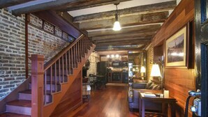 A cozy interior with a wooden staircase, a dining area, and a kitchen.