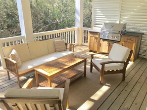 Enjoy al fresco dining on this outdoor deck with a barbecue grill and comfortable seating.
