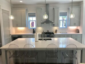 Enjoy cooking in this well-equipped kitchen with a central island, oven, and gas stove.