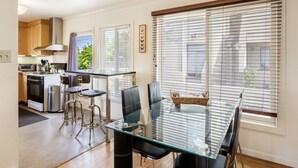 A modern kitchen with a dining area. - 2 Bedroom Condo Only 1 Block to UCB (Berkeley)