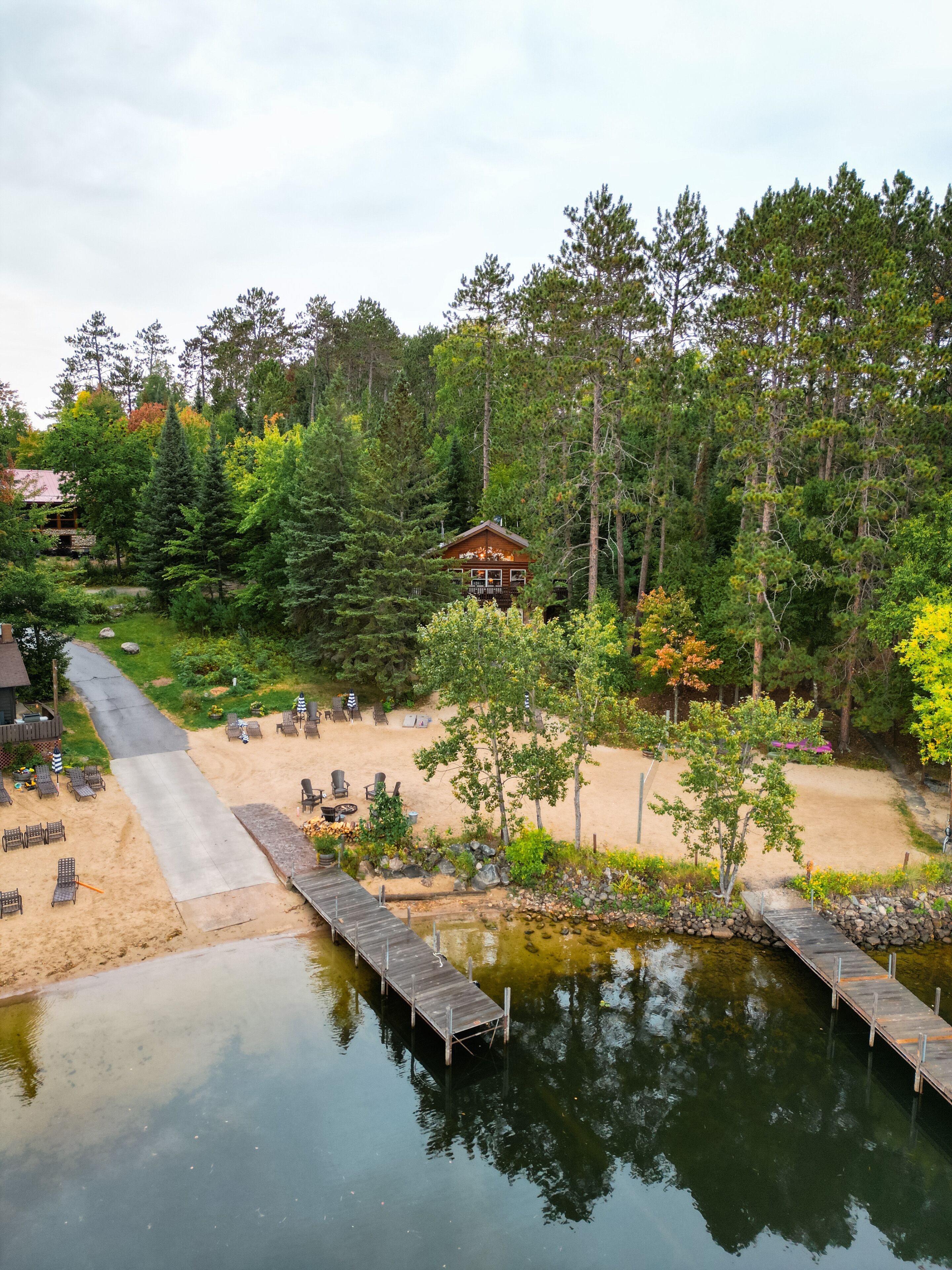 Ariel view from the lake, boat launch, sand beach, cabin and beach volley ball 