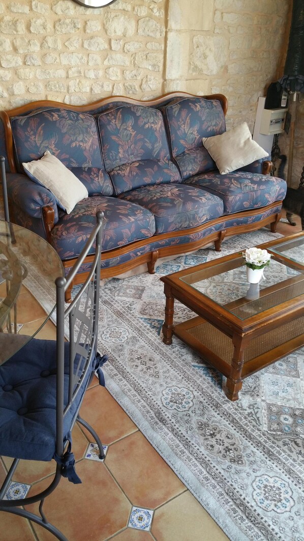 A living room with a sofa, a coffee table, and a chair.