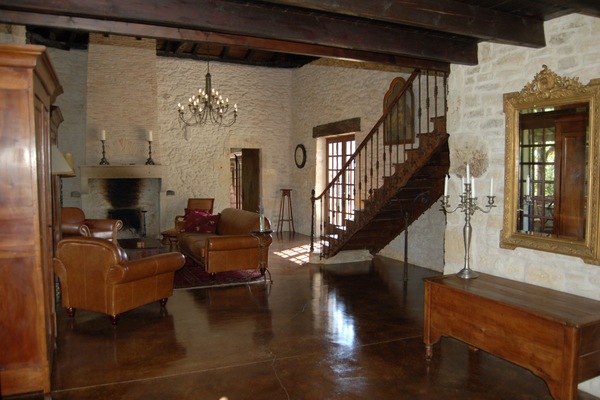 Living room with leather club furniture and 2 stone fireplaces