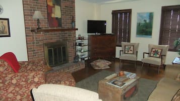 Televisión, chimenea, reproductor de DVD y libros