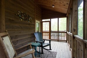 A wooden cabin with a porch, two rocking chairs, and a patterned rug. - Pet Friendly, Fireplace, Fire Pit, 1/2 mile from Lake Adger - Shelton's Way (Mill Spring)