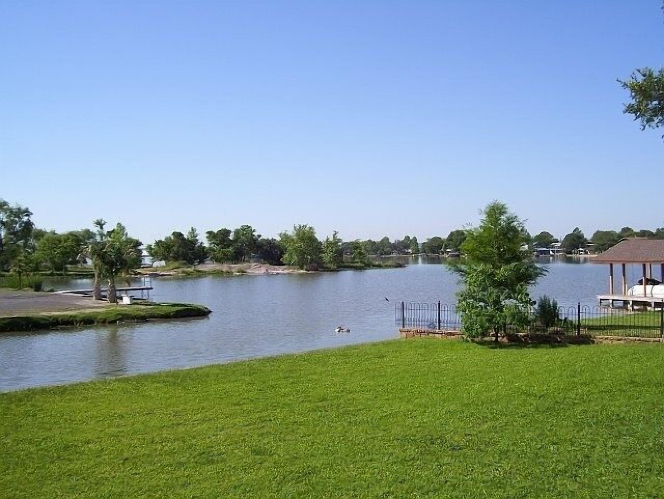 A Touch of Texas.  Stunning Lakehouse on three lots.  Huge yard and Patio Deck 