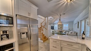 A modern kitchen with stainless steel appliances, a built-in oven, and a coffee maker. - Southside of 30A, Gated beachfront pool sleeps 7 , 2 min walk to Rosemary, NEW ! (seacrest beach)
