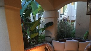A cozy outdoor seating area with a fire pit, cushioned chairs, and a sofa. - STEPS FROM THE BEACH - HUNTINGTON CONDO - BEAT THE HOTEL COSTS (Huntington Beach)