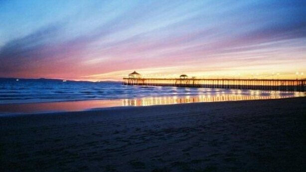A pier extending into calm waters at sunset with a clear sky. - STEPS FROM THE BEACH - HUNTINGTON CONDO - BEAT THE HOTEL COSTS (Huntington Beach)