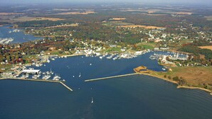 An aerial view of a marina with boats, docks, and surrounding residential areas. - Cottage with Harbor and Chesapeake Bay View in Rock Hall, MD (Rock Hall)