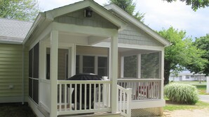 A single-story house with a covered porch and a small attached garage. - Cottage with Harbor and Chesapeake Bay View in Rock Hall, MD (Rock Hall)