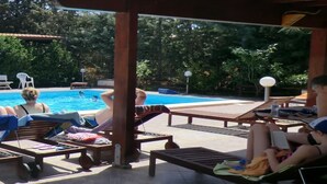 A poolside area with lounge chairs and a covered seating area. - EXCLUSIVE PRIVATE SAPPHIRE HOME, SALT WATER POOL, NATURAL CHLORINE, NO CHEMICALS (Partinico)