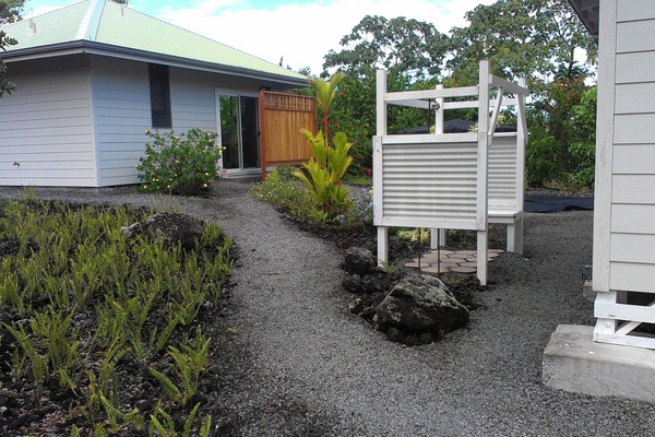 Your path from parking area to the cottage. Outdoor shower with bench at right.