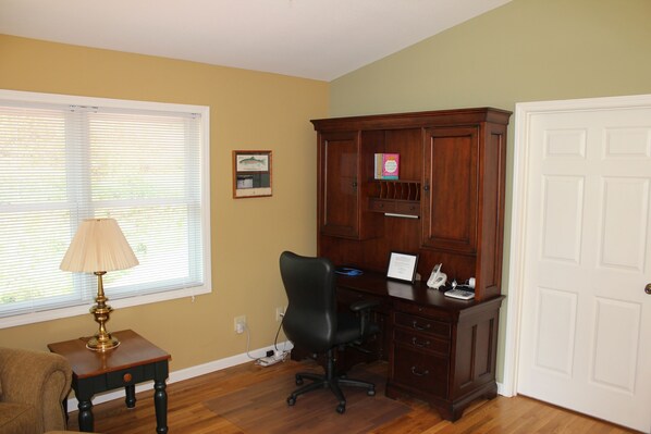 A room with a wooden desk, a black office chair, a lamp, and a filing cabinet. - Contemporary Mountain Vacation Home (Waynesville)