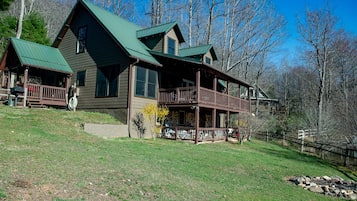 Experience the charm of a rustic retreat in this cozy cabin, featuring a spacious deck and large windows.