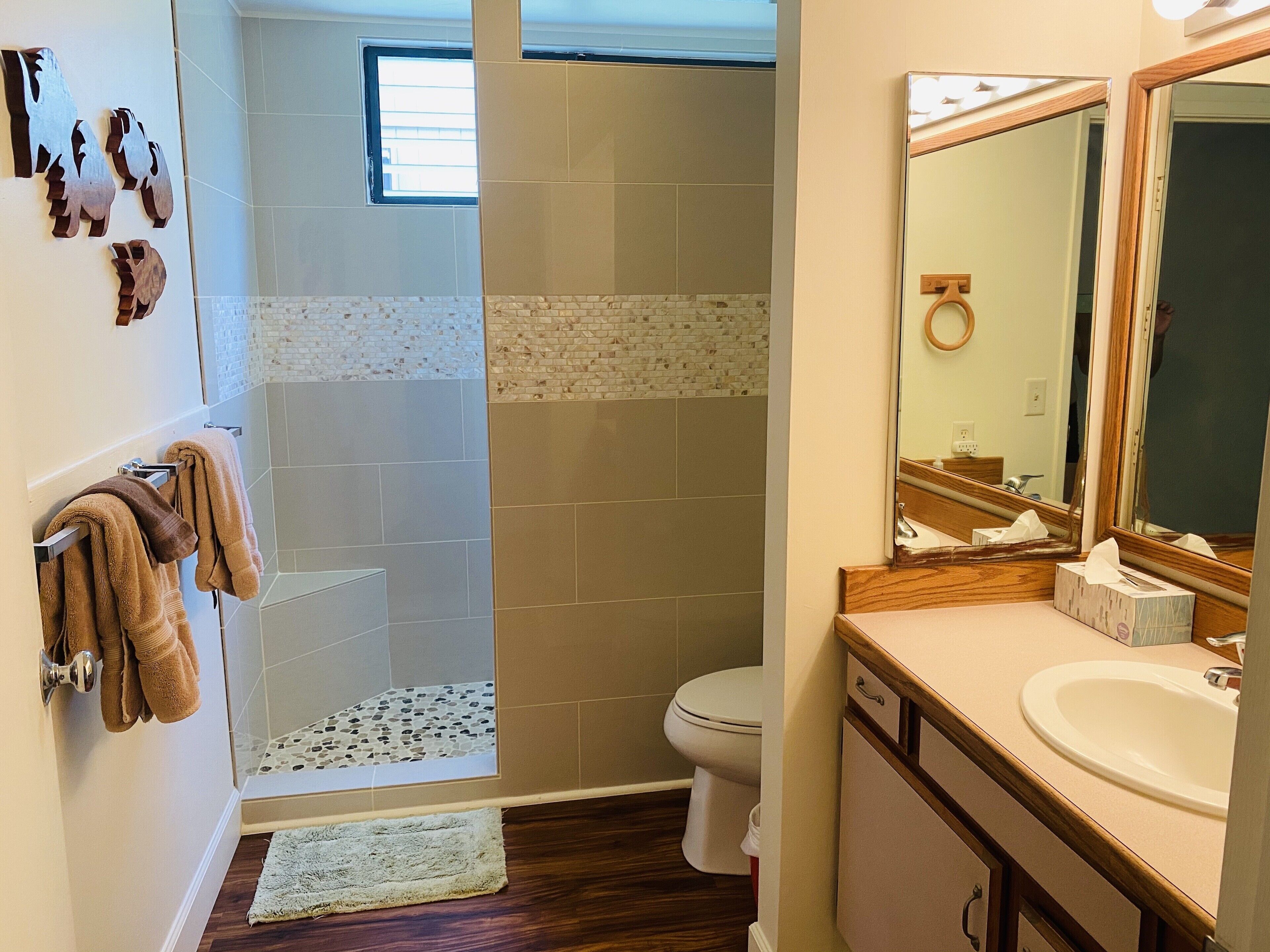 A bathroom with a shower, toilet, and sink.