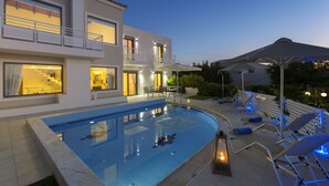 A modern two-story house with a swimming pool, outdoor seating, and a covered patio area. - Villas For Family Holidays (Rethymno)