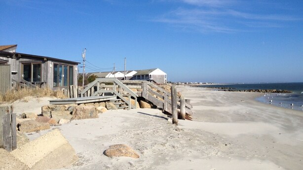 A beachside wooden structure with a staircase leading to a sandy area. - Private Sandy Beach, Truly Oceanfront,Private Decks, Free Kayak, Sleeps  5 (South Yarmouth)