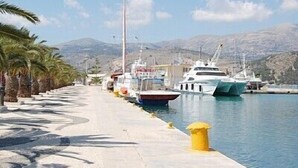A marina with yachts docked along a concrete walkway lined with palm trees. - 'Featured in Greece Magazine' Luxury Villa BREATHTAKING SEA VIEWS Kefalonia (Kourkoumelata)