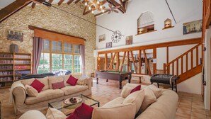 A spacious living room with a pool table, sofas, and a bookshelf. - ACABANES Luxury Dordogne villas, 20m Bergerac airport, 5m Chateau Vigiers golf (Thénac)