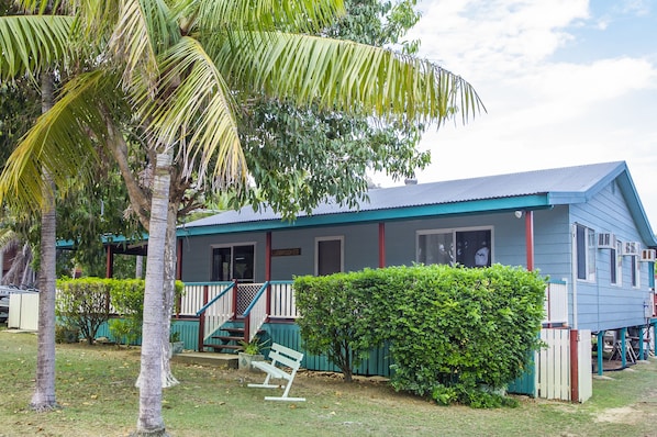 A two-story building with a blue exterior and a porch.