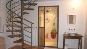 A bathroom with a spiral staircase, a sink, and a mirror. -  BASTIDON, POOL, 3000 M2 OF LAND, 2-4 PERS, APT, Luberon (Apt)