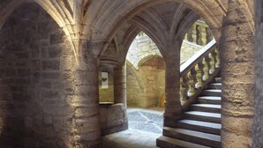 A stone staircase with arches in a historical building.
