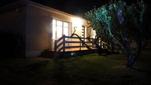 Ein Haus mit Veranda und Baum davor.