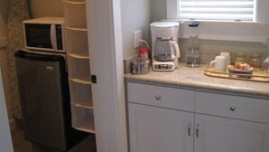 A compact kitchen with a refrigerator, microwave, and coffee maker on the counter. - Vineyard Guest House, Fabulous Views and Covered Parking (Paso Robles)