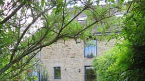 A stone building with a wooden fence in front.