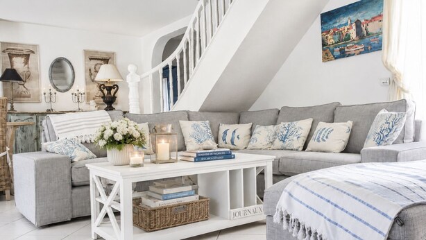 A cozy living room with a grey sofa, white coffee table, and a staircase. - Villa Philia near beaches, pool heated, 4 bedrooms with air conditionning (Cavalaire-Sur-Mer)